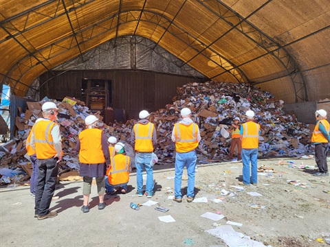 Tour group standing in front of the tipping floor